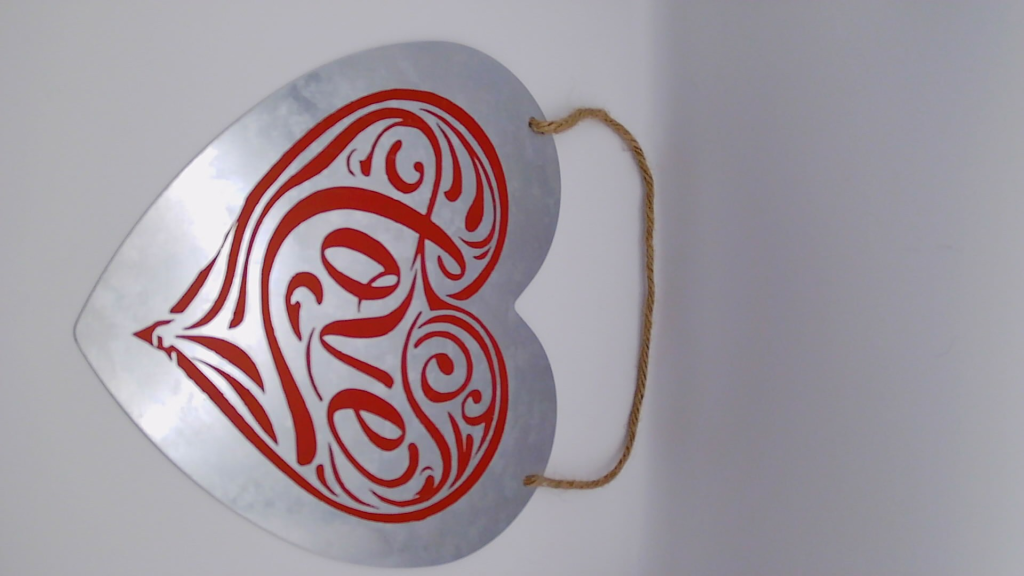 Metal sign with vinyl words.