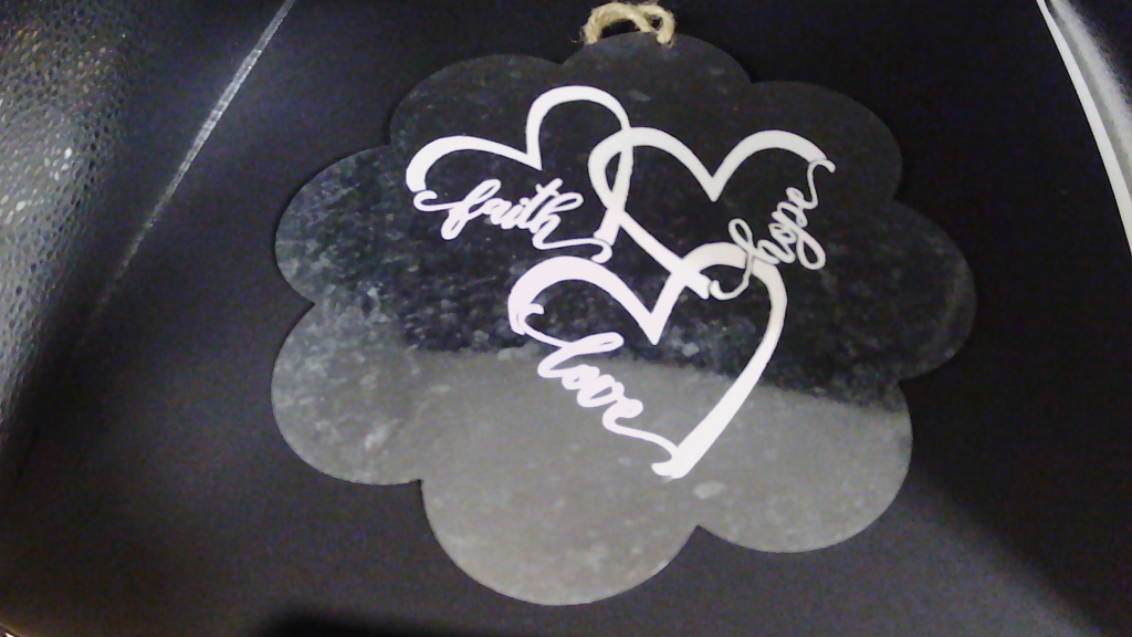 Metal sign with vinyl phrase.